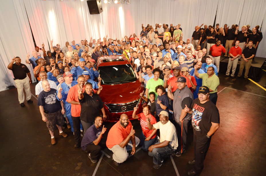 A group of people surrounding the 2013 Altima