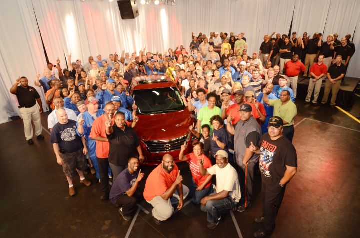A group of people surrounding the 2013 Altima