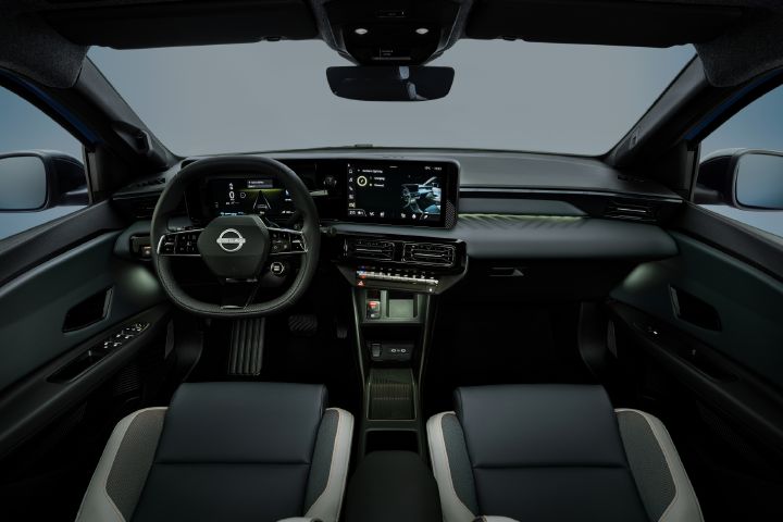 Driver-focused cockpit of the all-new MICRA, with dual digital displays and green ambient lighting.