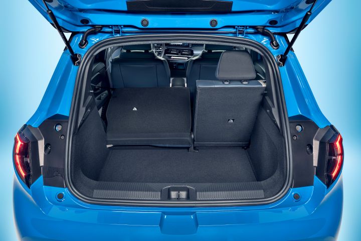 focused view of Micra's empty trunk space with open trunk door and one collapsed seat