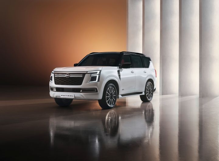 A white Patrol is photographed from a rear diagonal angle, displayed facing backward. The background features brown lighting and pillars.