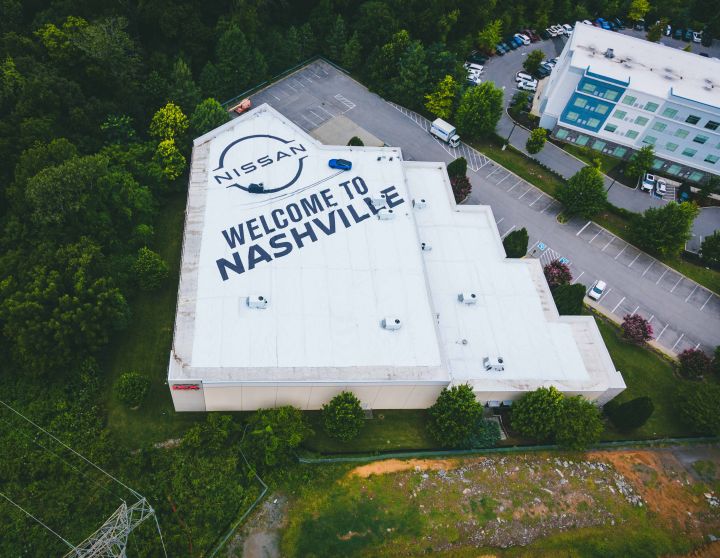 Aerial view of a building with the Nissan brand logo and "Welcome to Nashville" painted on the roof.