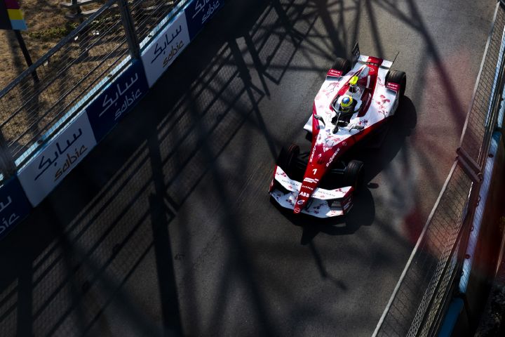 Eine Draufsicht auf einen rot-weißen Formel-E-Rennwagen, der auf der E-Prix Rennstrecke in London fährt. Im Cockpit ist Oliver Rowland zu sehen,