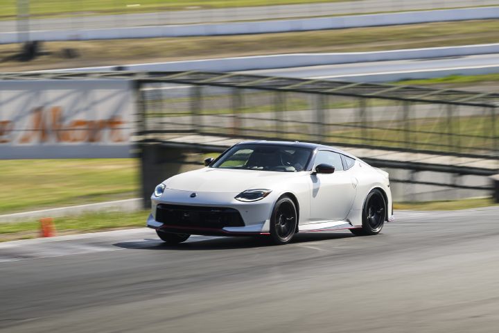 Angle view of the 2027 Nissan Z NISMO Manual Transmission driving fast on a racetrack.