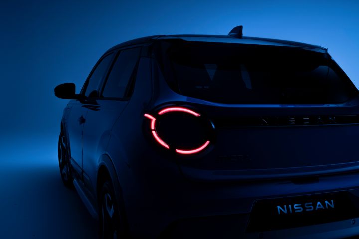 side rear view of Micra in dim light with left headlamps on