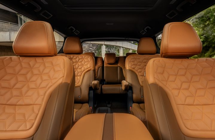 All three rows of seating inside the 2025 Nissan Armada, the seats are tan with quilted details.