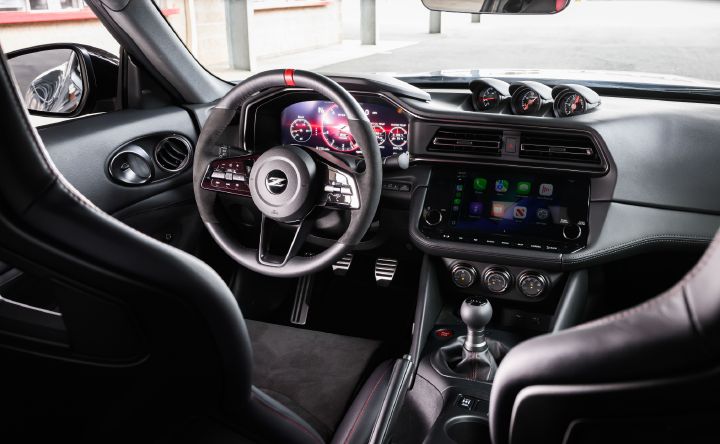 View of the driver seat, steering wheel and center dashboard inside the 2027 Nissan Z NISMO Manual Transmission.