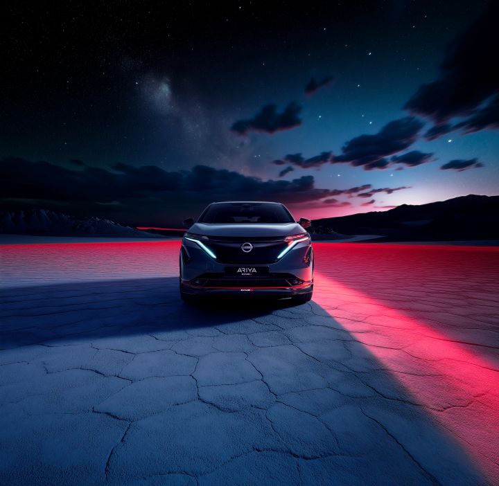 Side view static shot of the Ariya Nismo with red lighting in the background