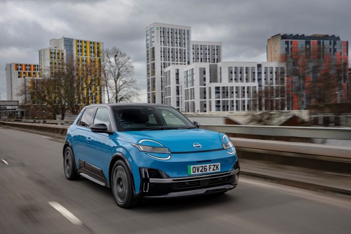 Image of Blue Nissan MICRA driving shot on open road