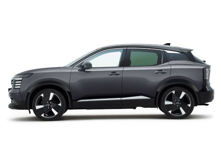 Side view of a dark gray Nissan Kicks. The vehicle faces right, highlighting its refined color and sharp styling.