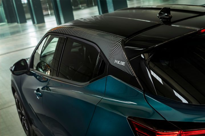 Close-up view of the Nissan JUKE Pulse rear side, highlighting the contrasting black roof, Pulse wave-graphic detail on the roof, and sculpted rear bodywork.