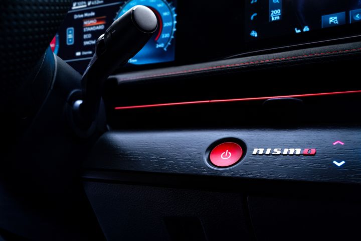 Interior of the Ariya NISMO showing the red start button and NISMO logo.