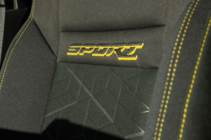 Close up of "SPORT" written in yellow stitching on the seat of the 2027 Nissan Frontier Sport Edition.