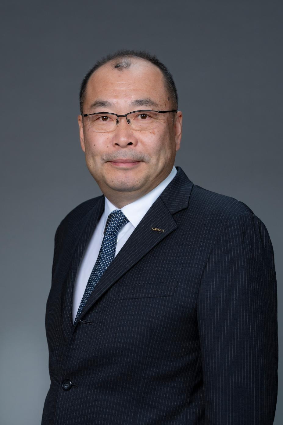 Portrait of Shohei Yamazaki (suit, tie and NISSAN corporate pin)