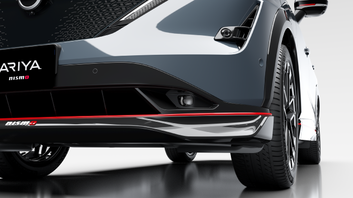 Static image of Nissan Ariya (close -up) showing the front bumper of the car with the Nismo logo and Ariya NISMO plates