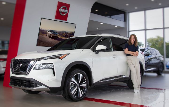 Karine Vanasse leaning against the 2021 Nissan Rogue.