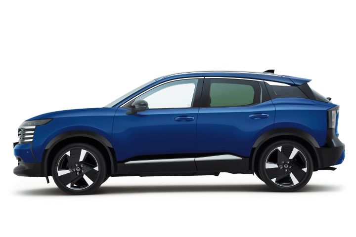 Side view of a deep blue Nissan Kicks. The vehicle faces right, with its vivid color emphasized against the white backdrop.