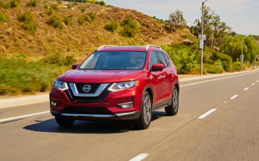 2020 Nissan Rogue red in color driving towards the camera