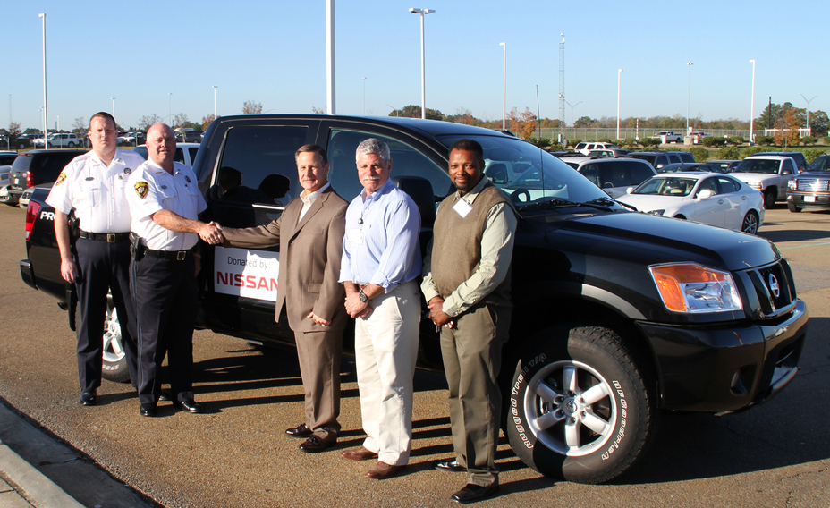 Employees from Nissan's Canton, Miss. vehicle assembly plant present a