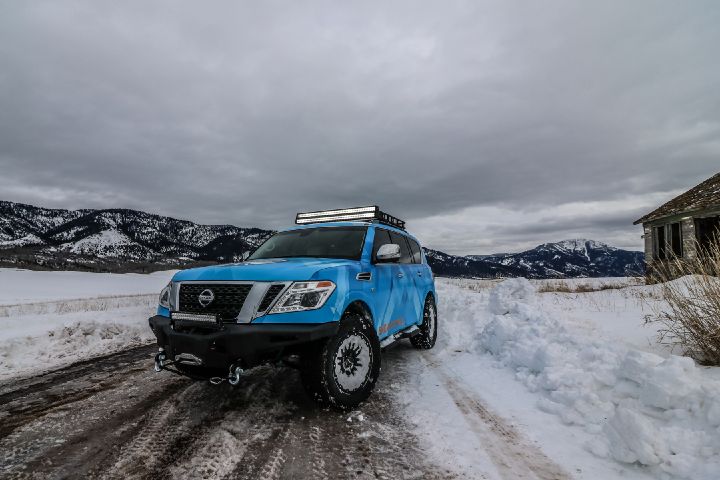 A Nissan Armada parked angled on a snowy road