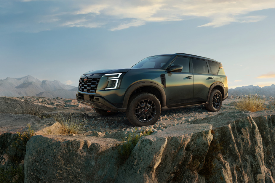 Patrol PRO-4X parked on mountain rocks under golden light