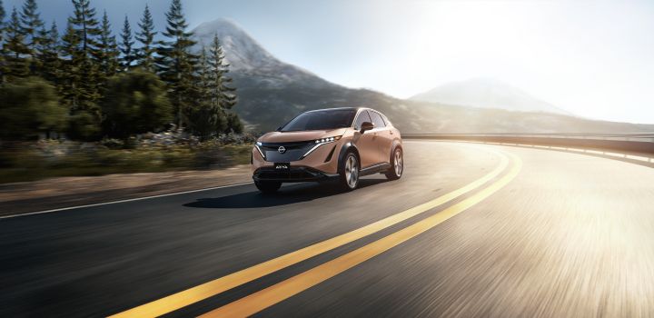 The Nissan Ariya driving down picturesque mountain road