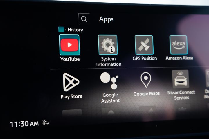 Close-up of the Nissan X‑Trail infotainment touchscreen, displaying connected services and smartphone integration apps including Amazon Alexa, Apple CarPlay, YouTube and Android Auto.