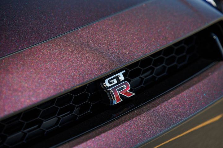 Close-up of the GT‑R logo on the grill of the Midnight Purple 2024 GT‑R T-spec Takumi edition.