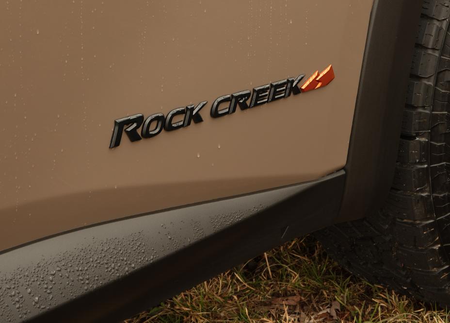 2023 Rock Creek badge with a orange mountain badge.