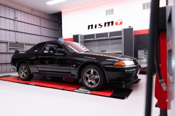 Front view of a black R32 GT‑R in the workshop of the new NISMO Performance Center Melbourne.