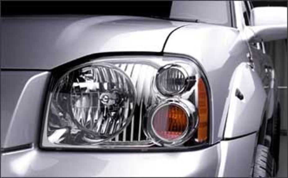 Gray 2002 Nissan Frontier close up on a headlight