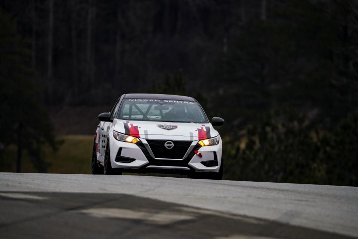 Head on view of a Nissan Sentra Cup car driving towards the camera