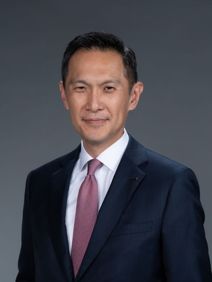 Portrait of Stephen Ma (suit, tie and NISSAN corporate pin)