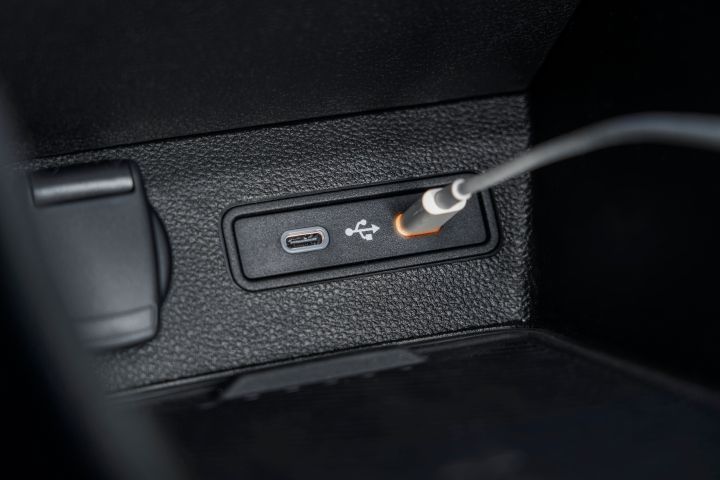detailed image of two USB-c sockets with one plug charging revealing orange light