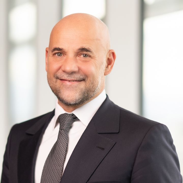 Portrait of Guillaume Cartier (suit, tie and NISSAN corporate pin)