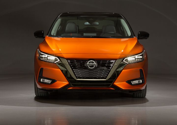 A Nissan Sentra parked in a studio.