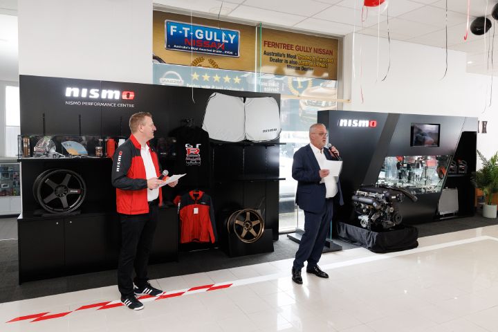 Aftersales director, Michael Hill alongside Dealer Principal Michael Banjanin with a microphone giving a speech to guests.