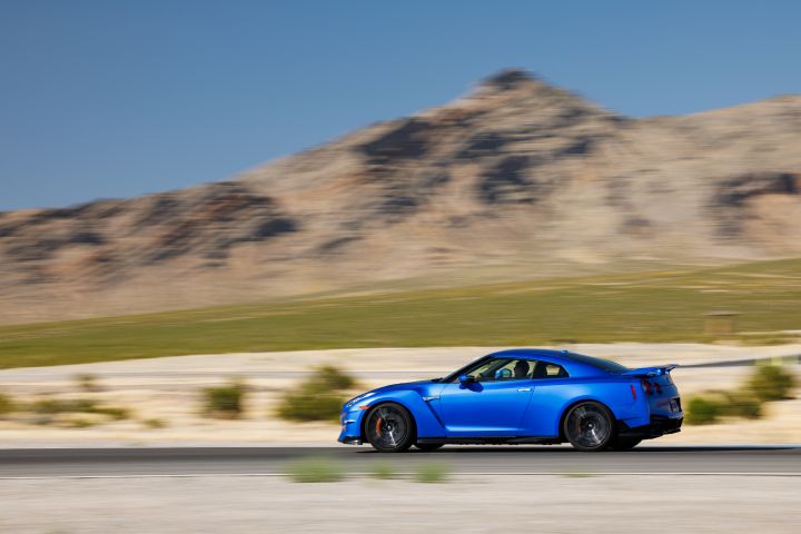 Profile of 2024 GT‑R Special Edition on a race track with desert and a mountain in the background
