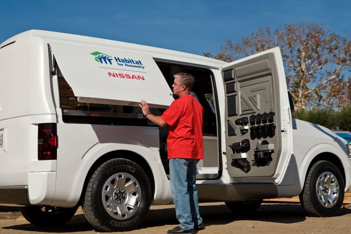 a man in red shirt viewing a Nissan NV2500 Concept