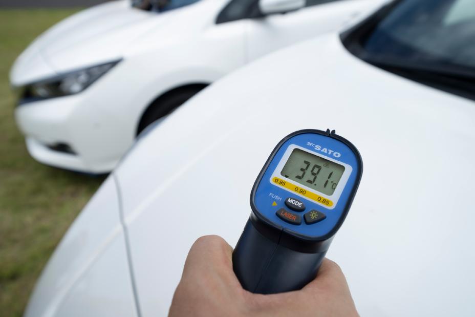 Close-up temperature gun on Nissan Leaf paint
