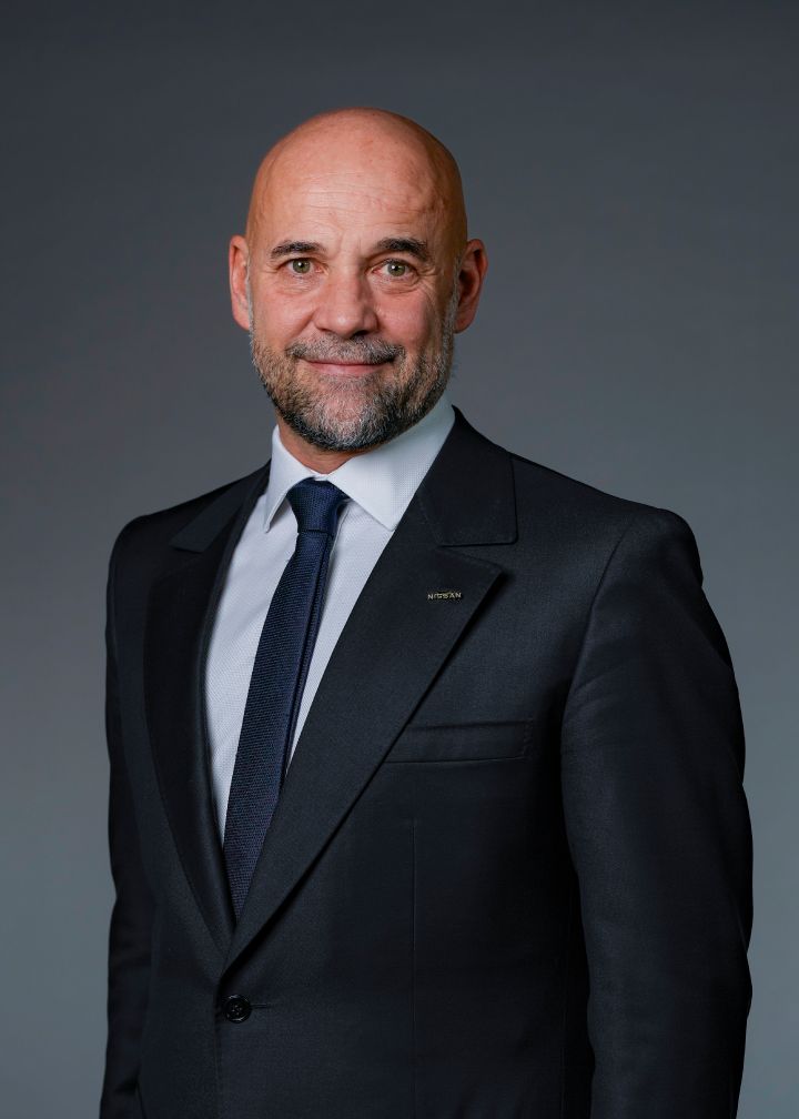 Portrait of Guillaume Cartier (suit, tie and NISSAN corporate pin)
