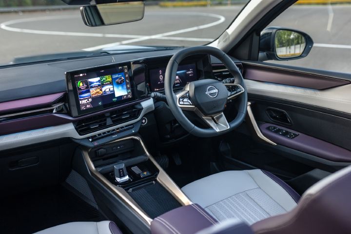Wide view of the Tekton cabin featuring a dual-screen dashboard, premium materials and a spacious front seating area.