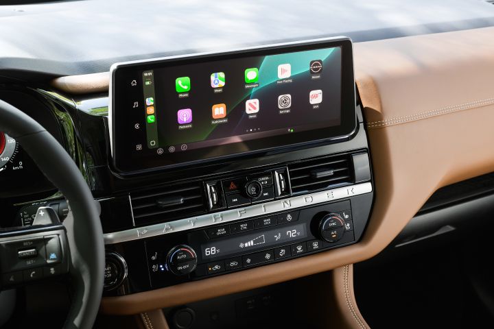 The center dashboard display inside the 2026 Nissan Pathfinder featuring and iOS homepage.