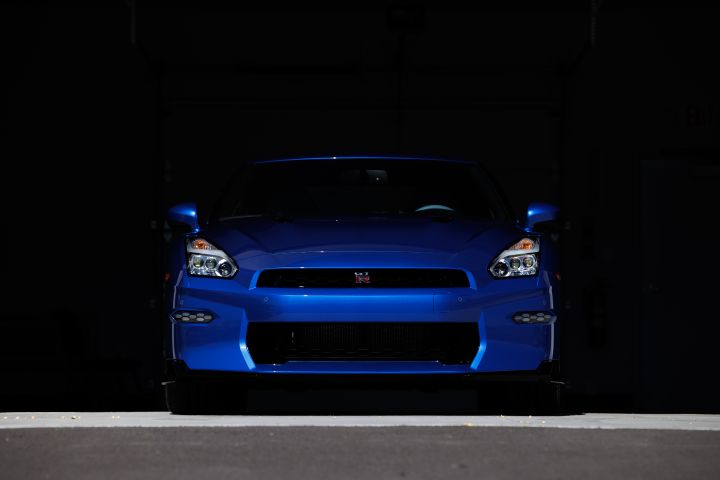 Front end of a blue 2024 GT‑R Special Edition parked with a dark shadow above the car