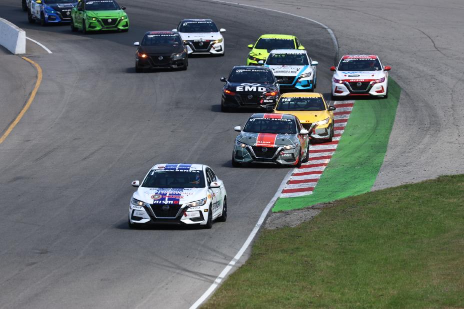 Several race cars driving on a race track