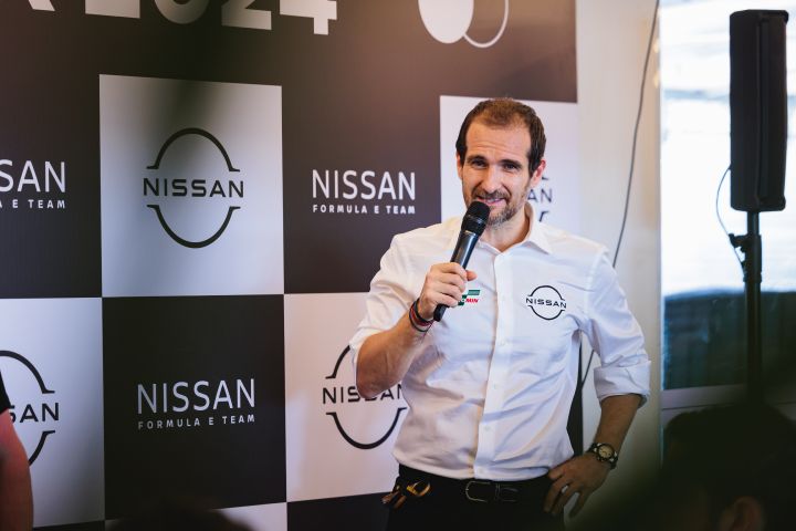 Tommaso Volpe, managing director and team principal, Nissan Formula E Team with a microphone in his hand with Nissan branding behind him.