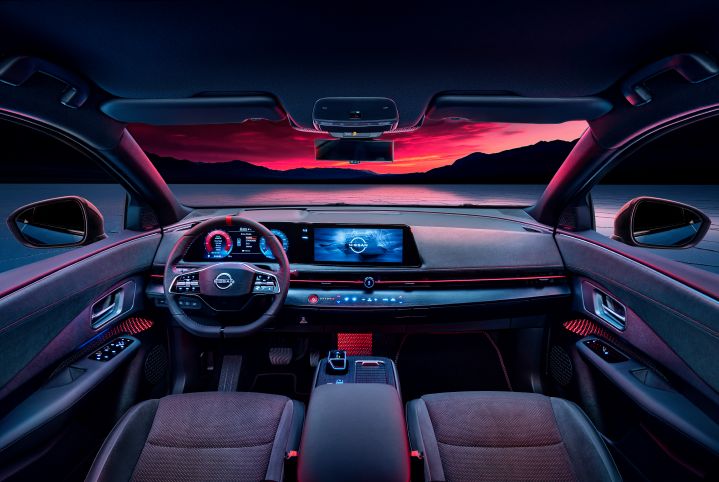 Shot of interior cabin of the Ariya NISMO showing the Nissan logo on the main screen.