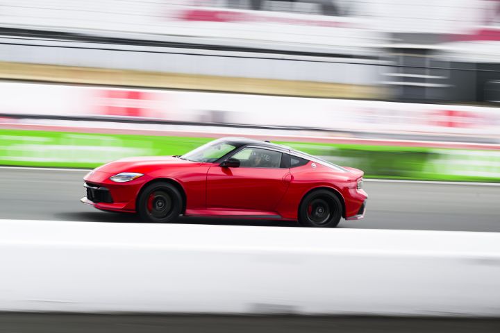 Left profile view of the 2027 Nissan Z NISMO Manual Transmission driving on a racetrack.