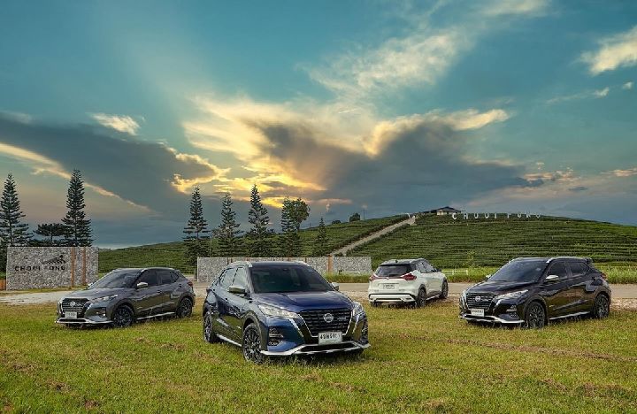 Four cars all facing opposite directions on top of grass