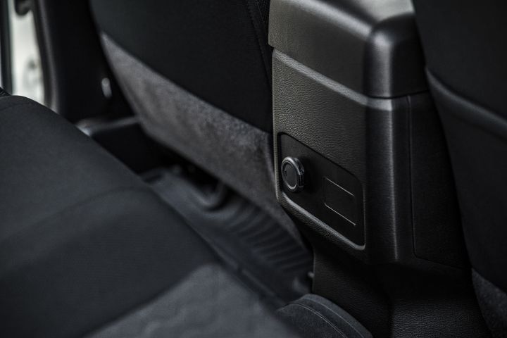 2026 Nissan Navara SL dual cab ute finished in Alpine White featuring a rear console close-up with the 12V socket, plastic trim and floor area.
